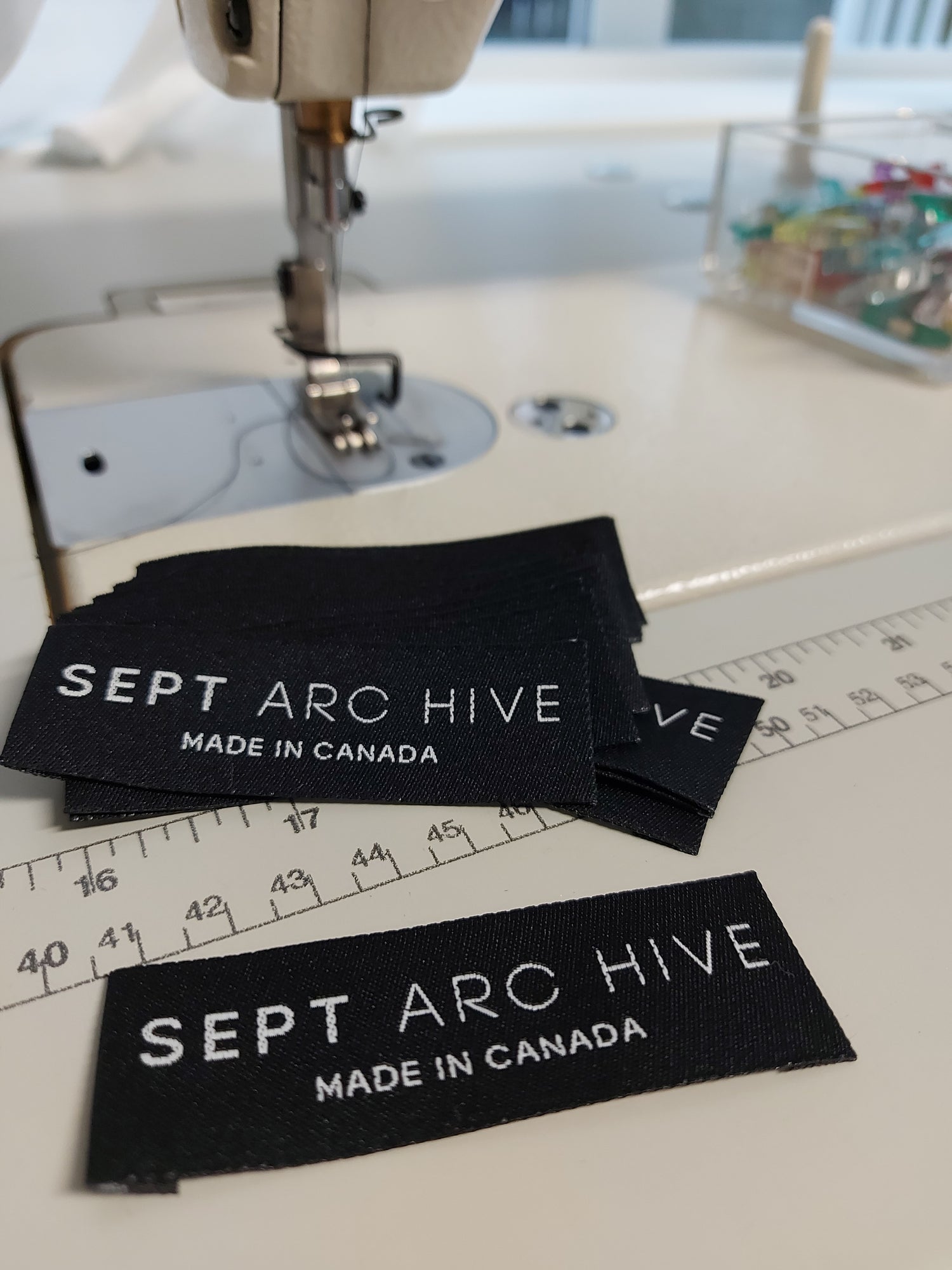 Black labels with 'SEPT ARCHIVE' text on a sewing machine. Made in Canada.