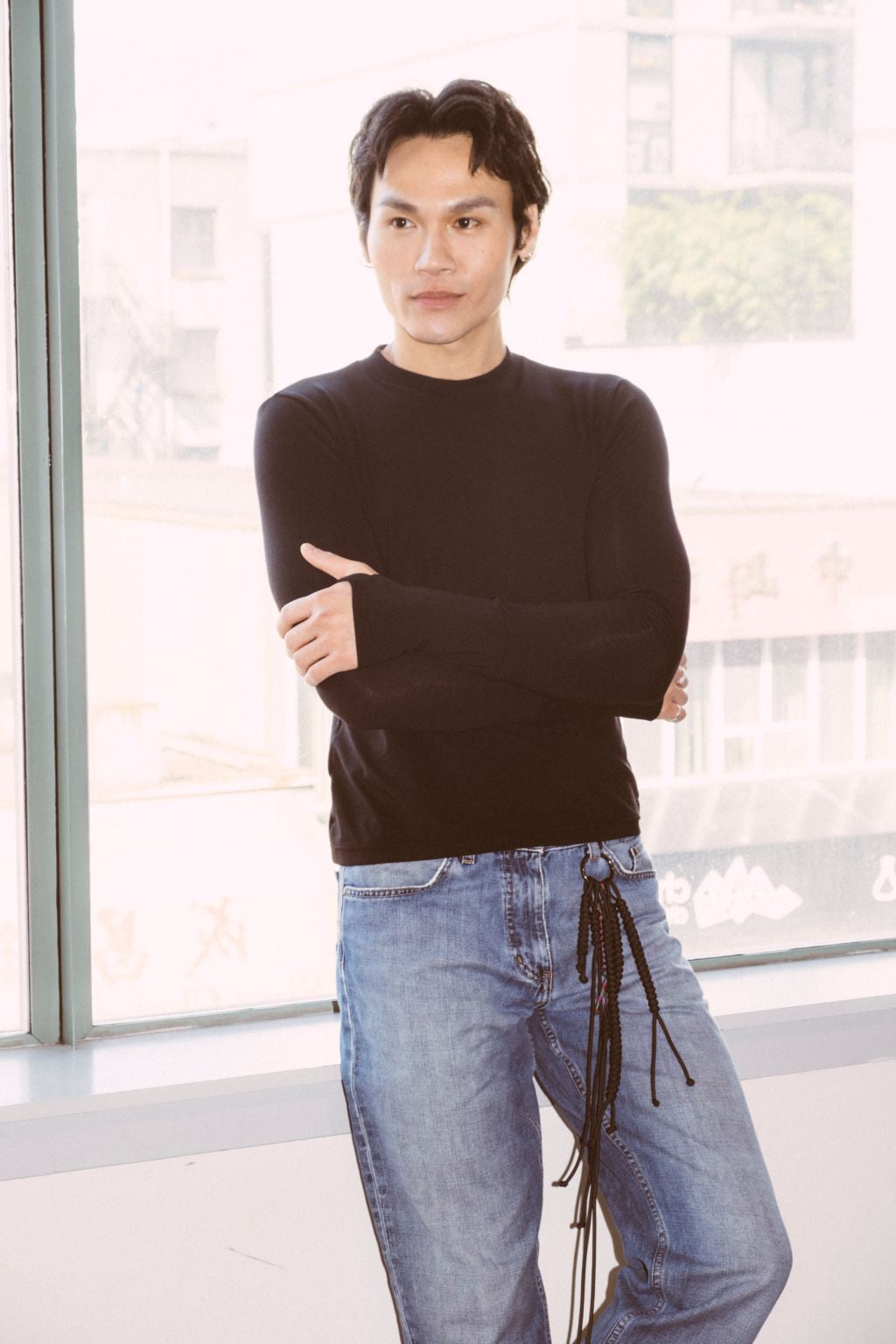 Comfy black long sleeve shirt worn by a male. Eco friendly shirt. Thumbs up Knit Long Sleeve Shirt in black by September Archive. Photographed by Trevor Brady.