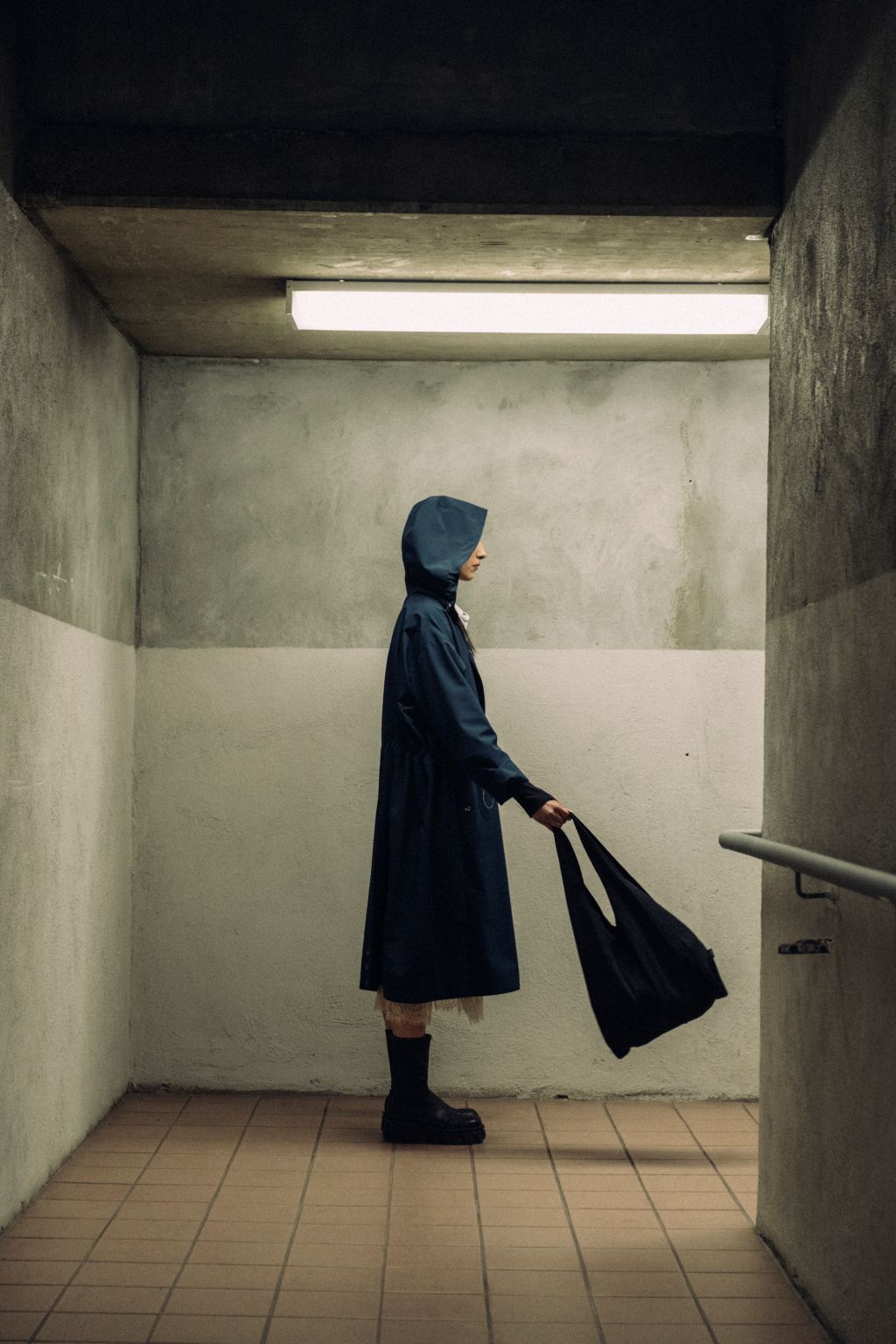 Female wearing a black organic cotton bag. Atelier Tote in black by September Archive. Photograph by Trevor Brady.