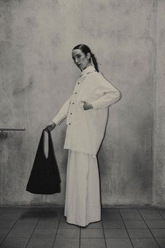 Female wearing a black organic cotton bag. Atelier Tote in black by September Archive. Photograph by Trevor Brady.