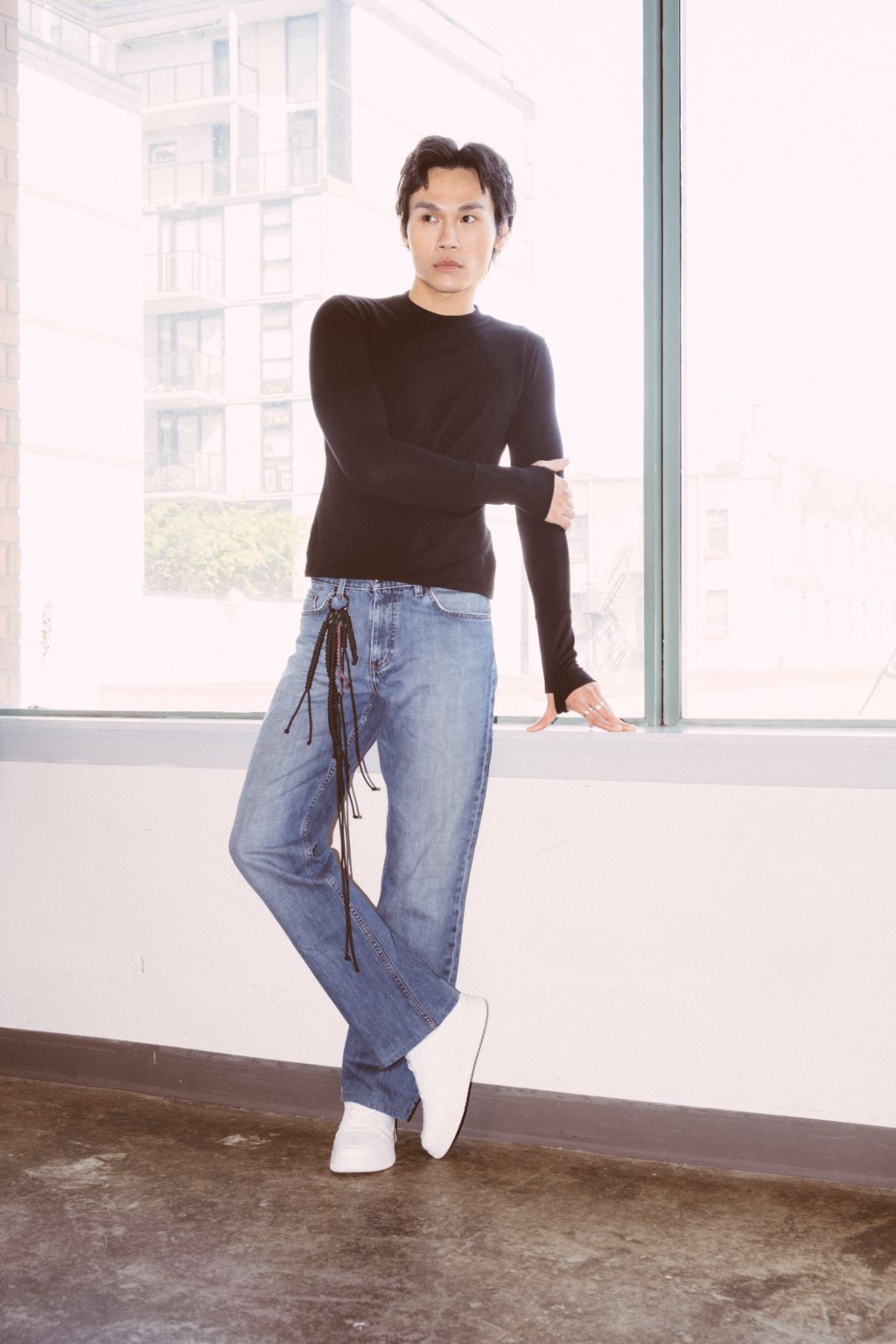 Comfy black long sleeve shirt worn by a male. Eco friendly shirt. Thumbs up Knit Long Sleeve Shirt in black by September Archive. Photographed by Trevor Brady.