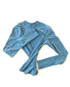A flat lay of an organic comfy vibrant blue long sleeve shirt. Thumbs up Knit Long Sleeve Shirt in Stellar Sky by September Archive. Photographed by Sheila Wong.