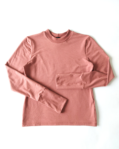 A flat lay of an organic comfy pink long sleeve shirt. Thumbs up Knit Long Sleeve Shirt in Terracotta Blush by September Archive. Photographed by Sheila Wong.